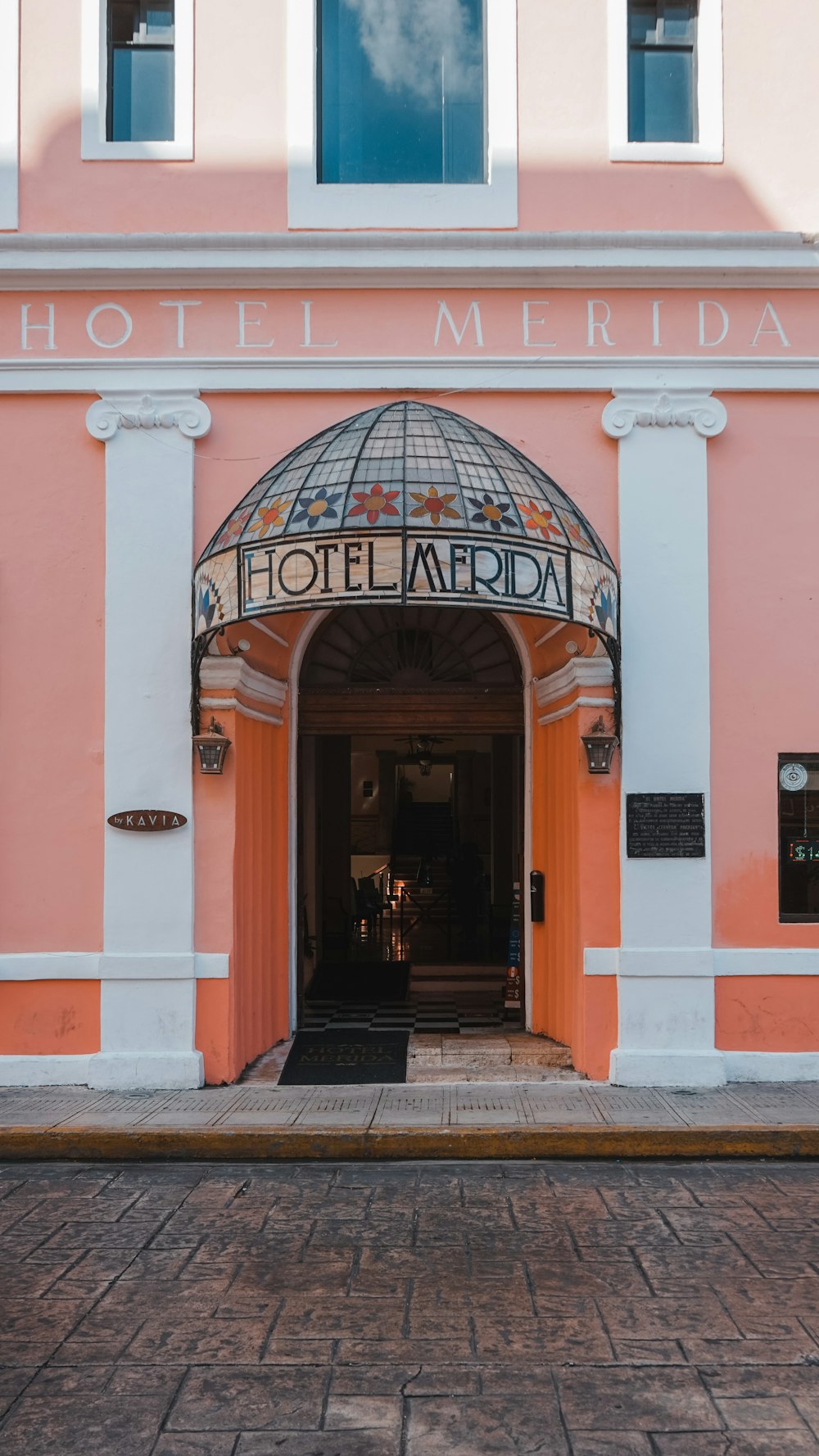 a pink and white building with a clock on the front of it