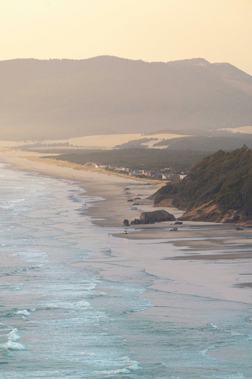 a view of a beach with a mountain in the background