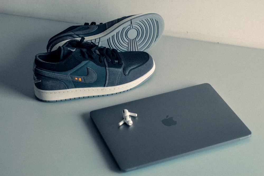 a pair of shoes and a laptop on a table