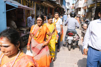 A colorful street scene in Dhaka featuring people wearing traditional and contemporary Bangladeshi fashion.