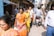Travelers in traditional attire walking through the vibrant streets of Varanasi.