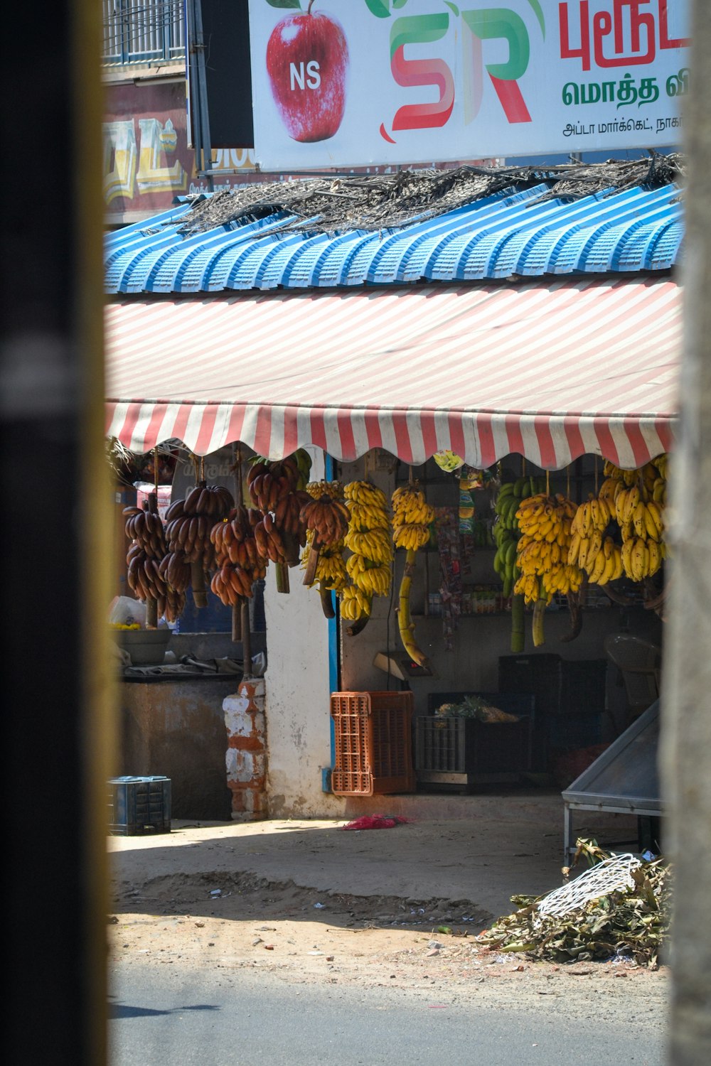 a store with bananas hanging from it's roof