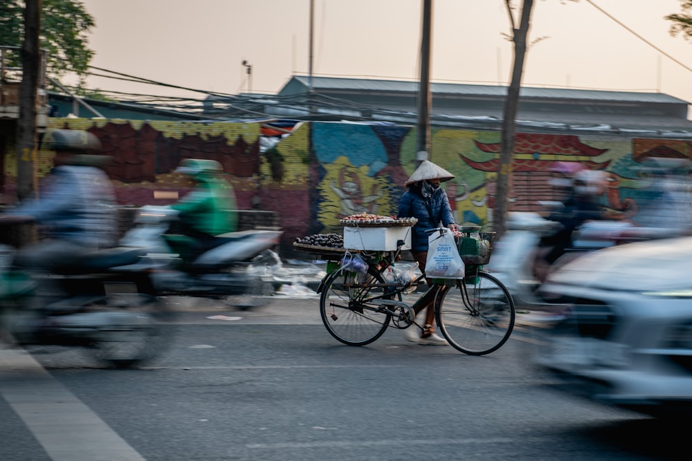 a person riding a bike down a street