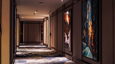 Stylish hallway featuring violet artwork and warm lighting.