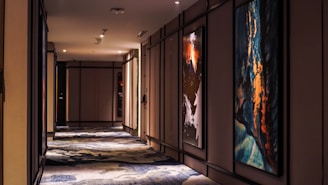 Stylish hallway featuring violet artwork and warm lighting.