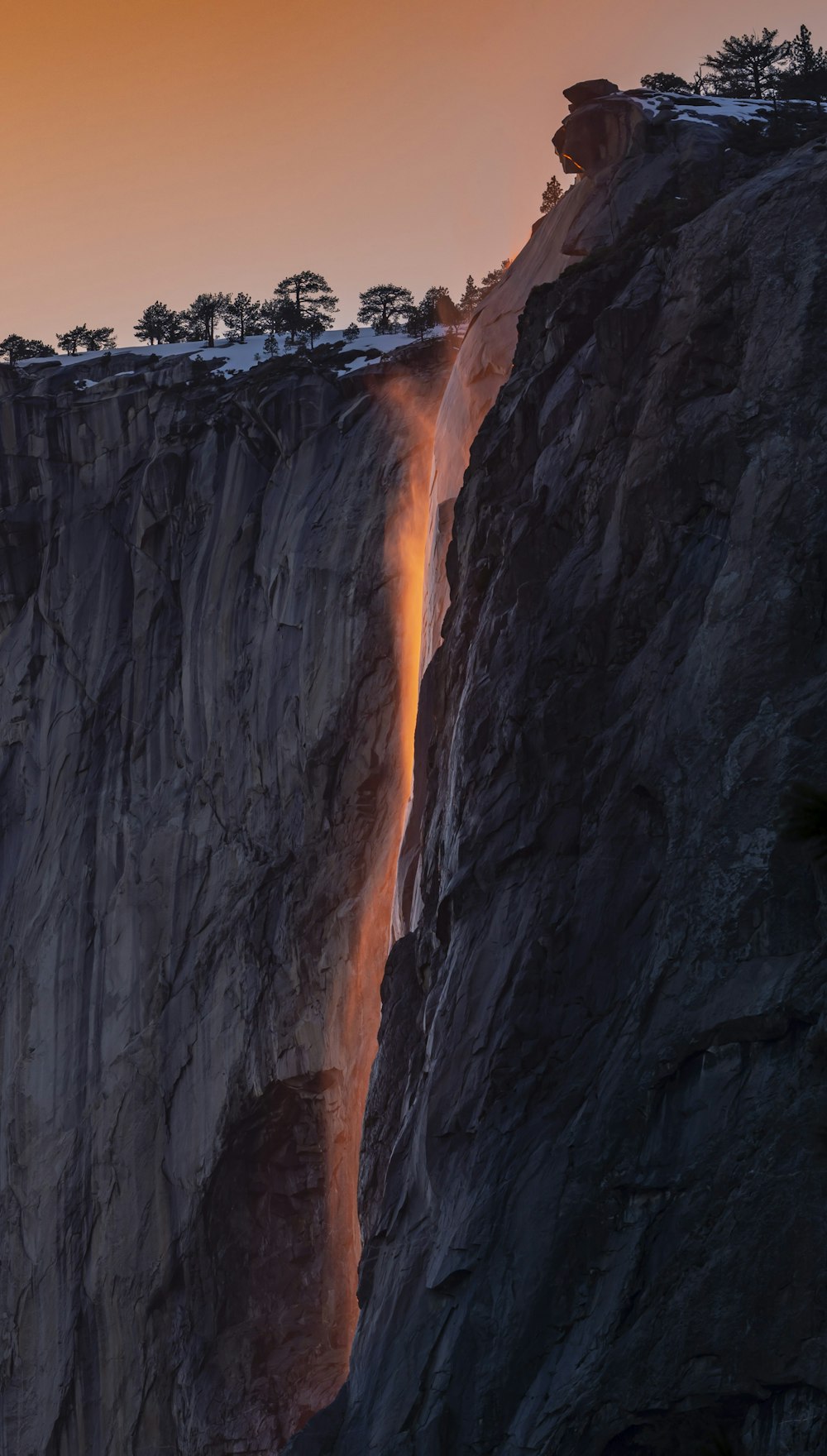 a large waterfall flowing down a mountain side