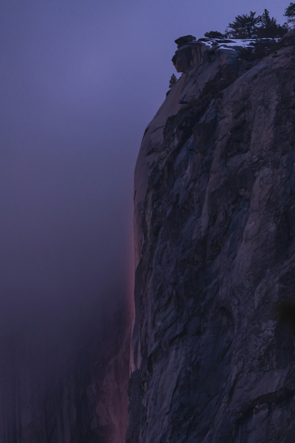 a person standing on top of a cliff