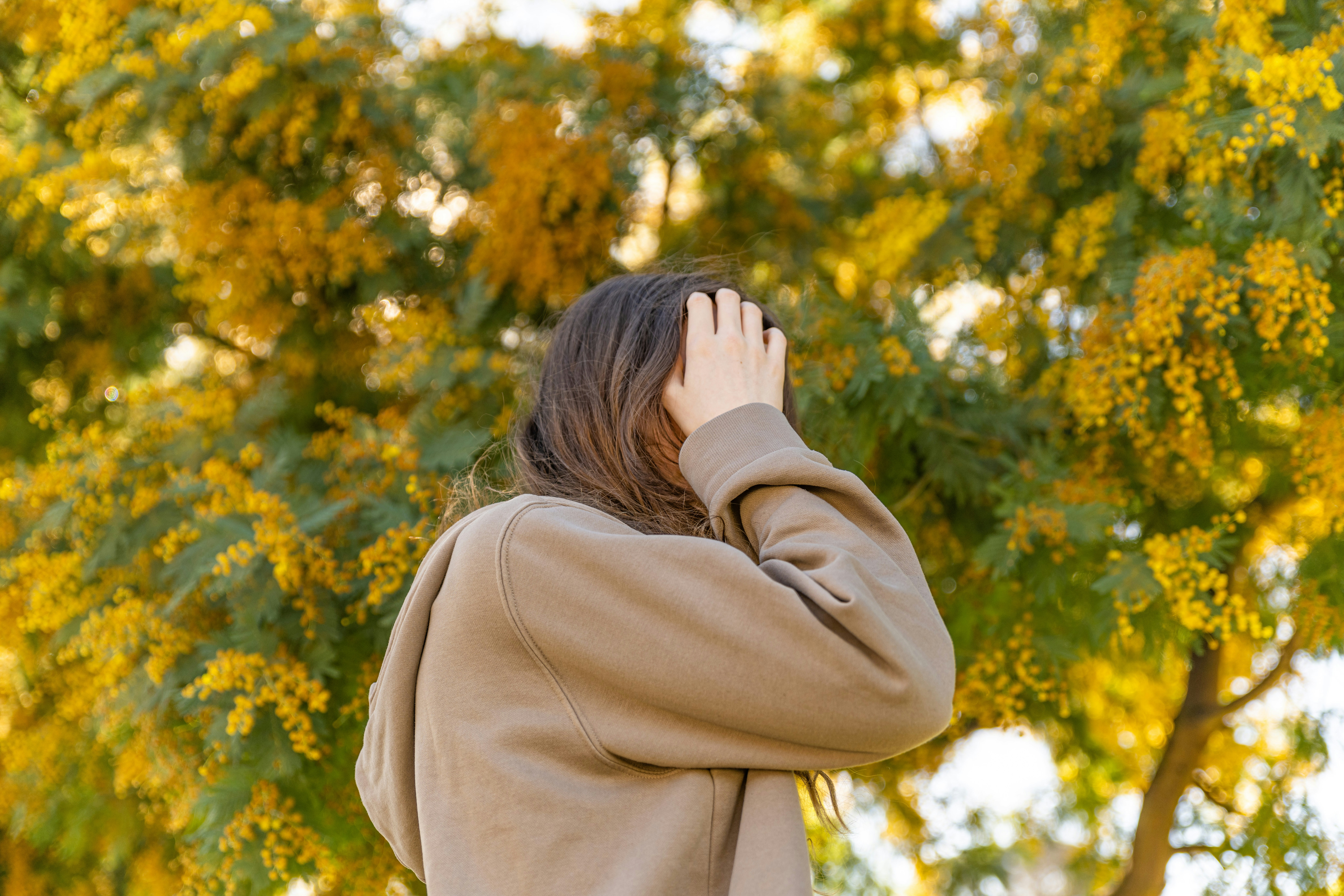a woman covering her face with her hands