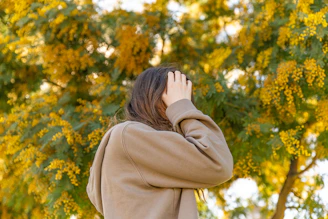 a woman covering her face with her hands
