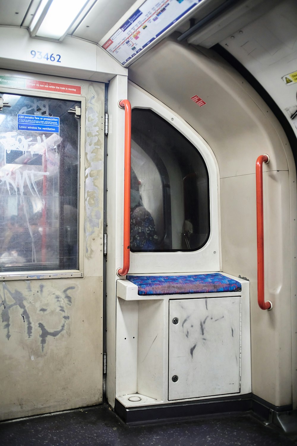 the inside of a subway car with graffiti on the walls