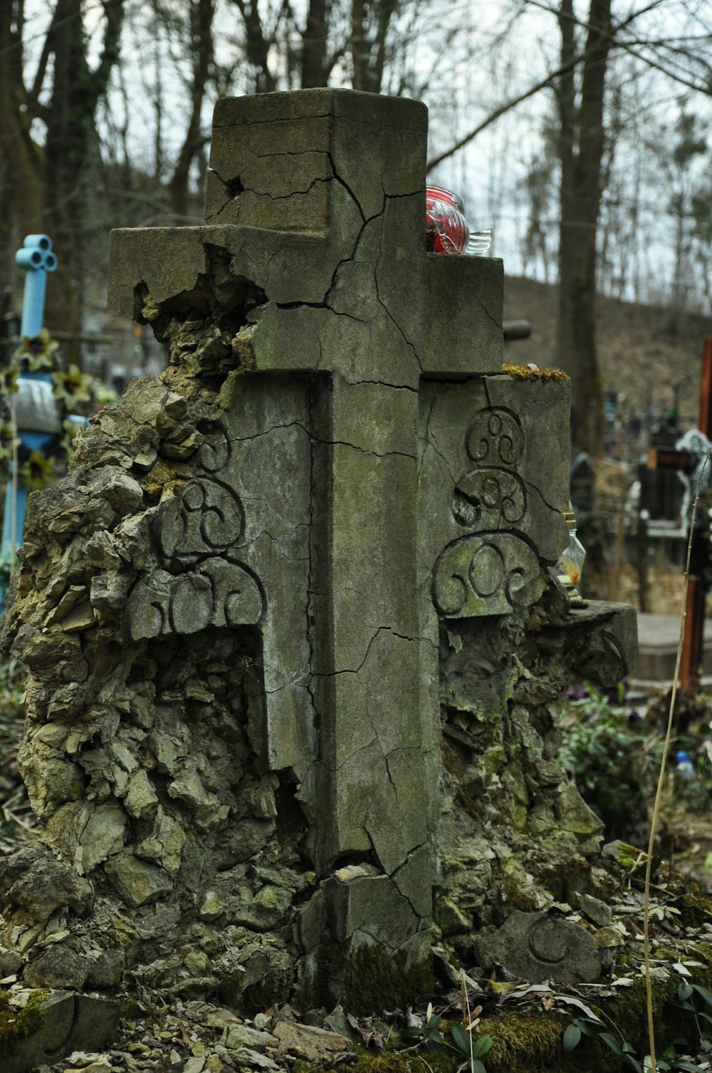 a stone grave with a cross carved into it