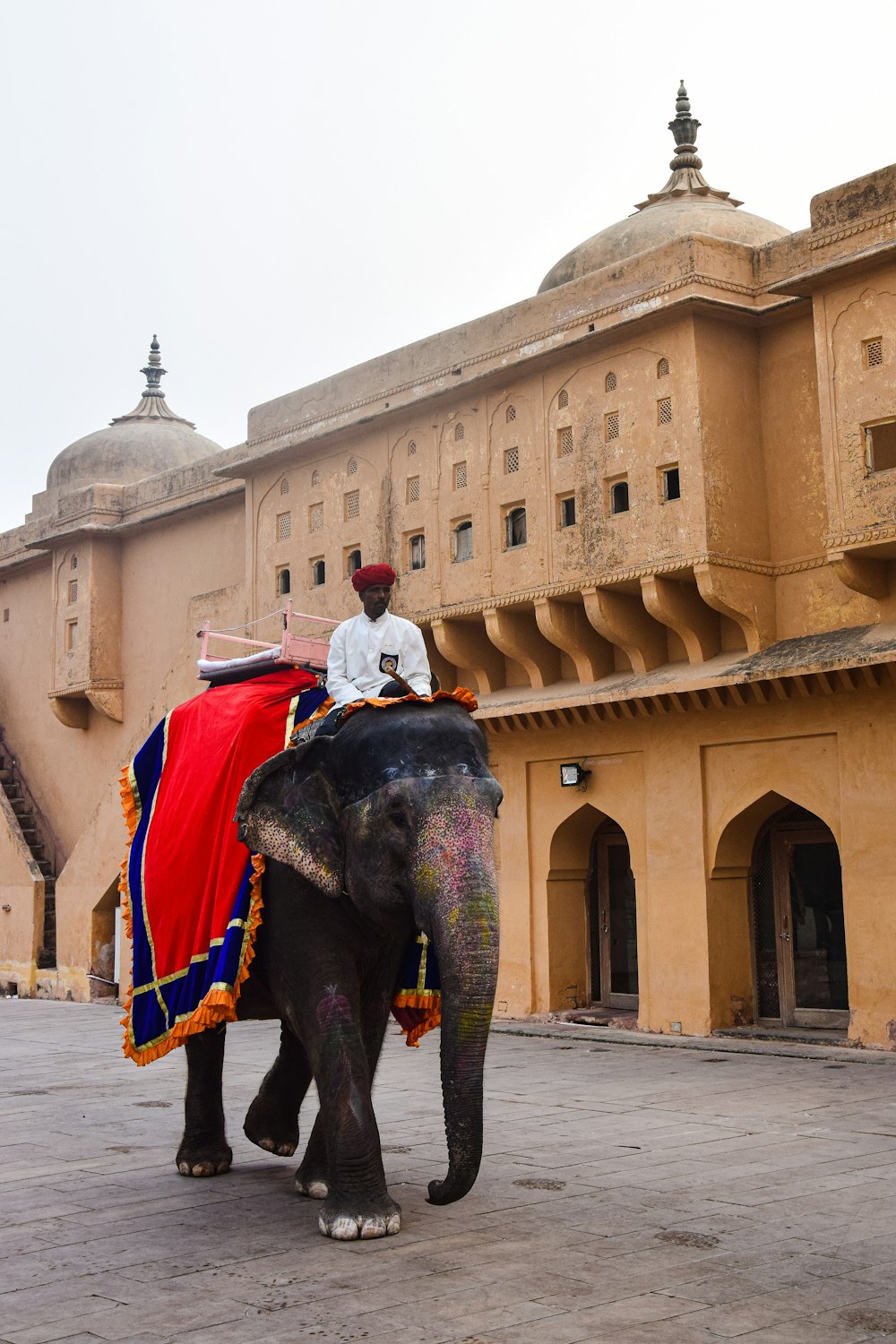 a man riding on the back of an elephant