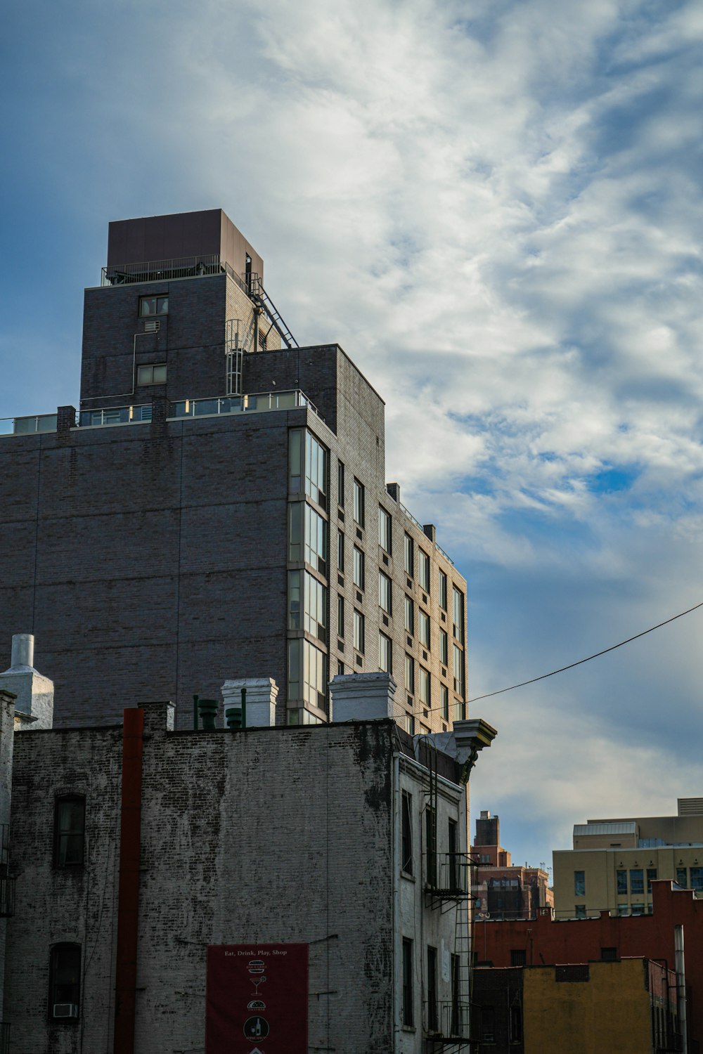 a very tall building sitting next to a tall building