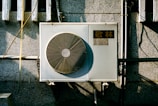 a wall mounted air conditioner mounted on the side of a building