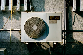 a wall mounted air conditioner mounted on the side of a building