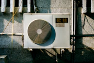 a wall mounted air conditioner mounted on the side of a building