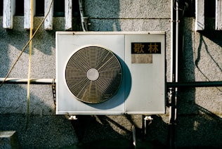 a wall mounted air conditioner mounted on the side of a building