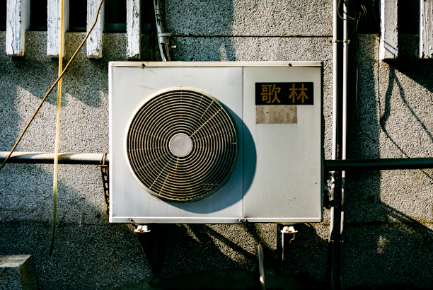 a wall mounted air conditioner mounted on the side of a building