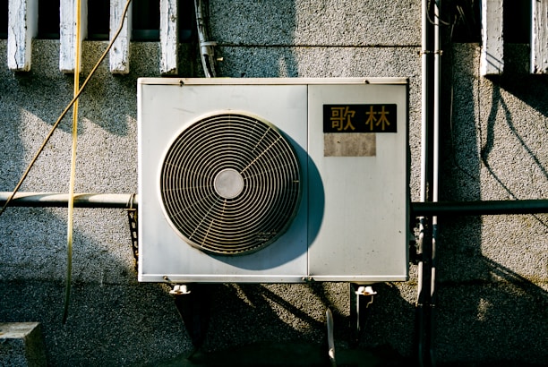 a wall mounted air conditioner mounted on the side of a building