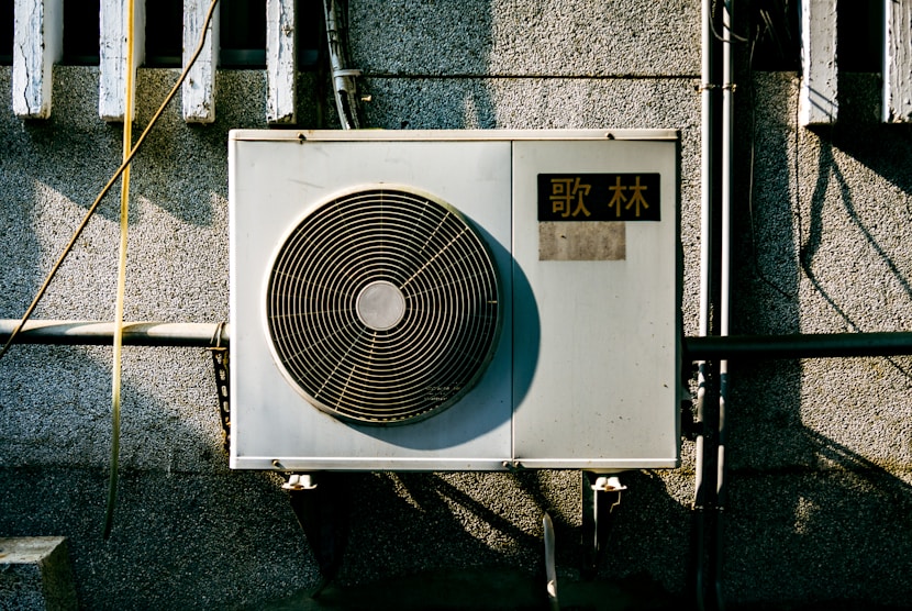 a wall mounted air conditioner mounted on the side of a building
