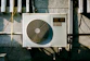 a wall mounted air conditioner mounted on the side of a building