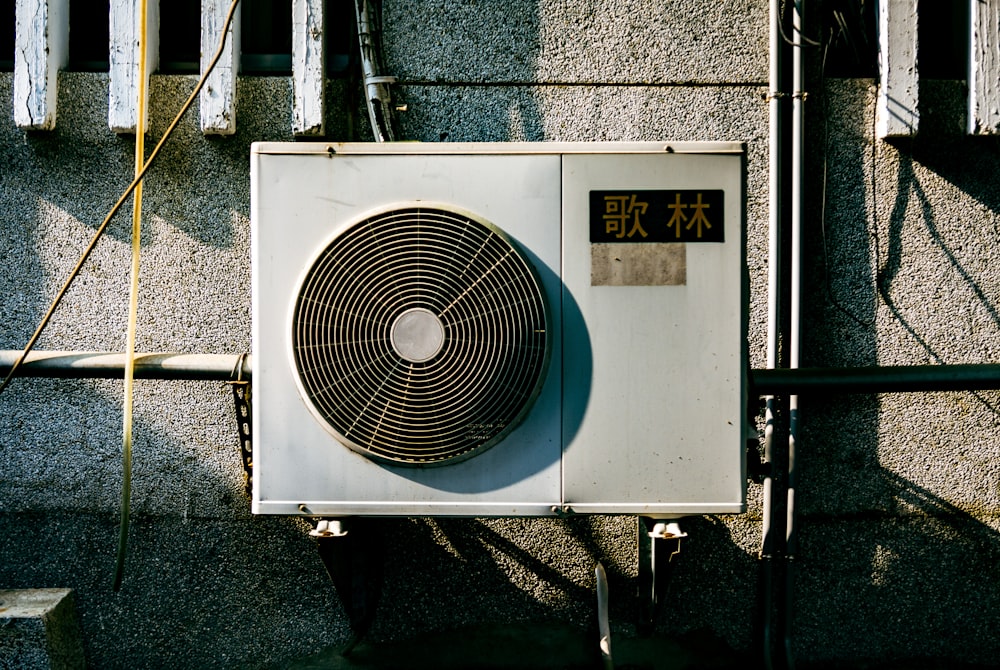 a wall mounted air conditioner mounted on the side of a building