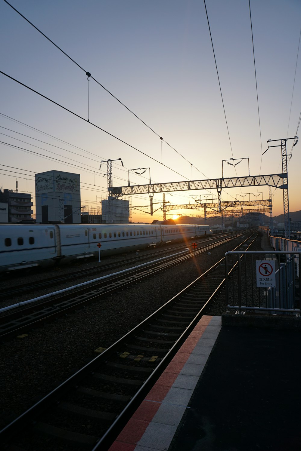 a train traveling down train tracks next to a train station