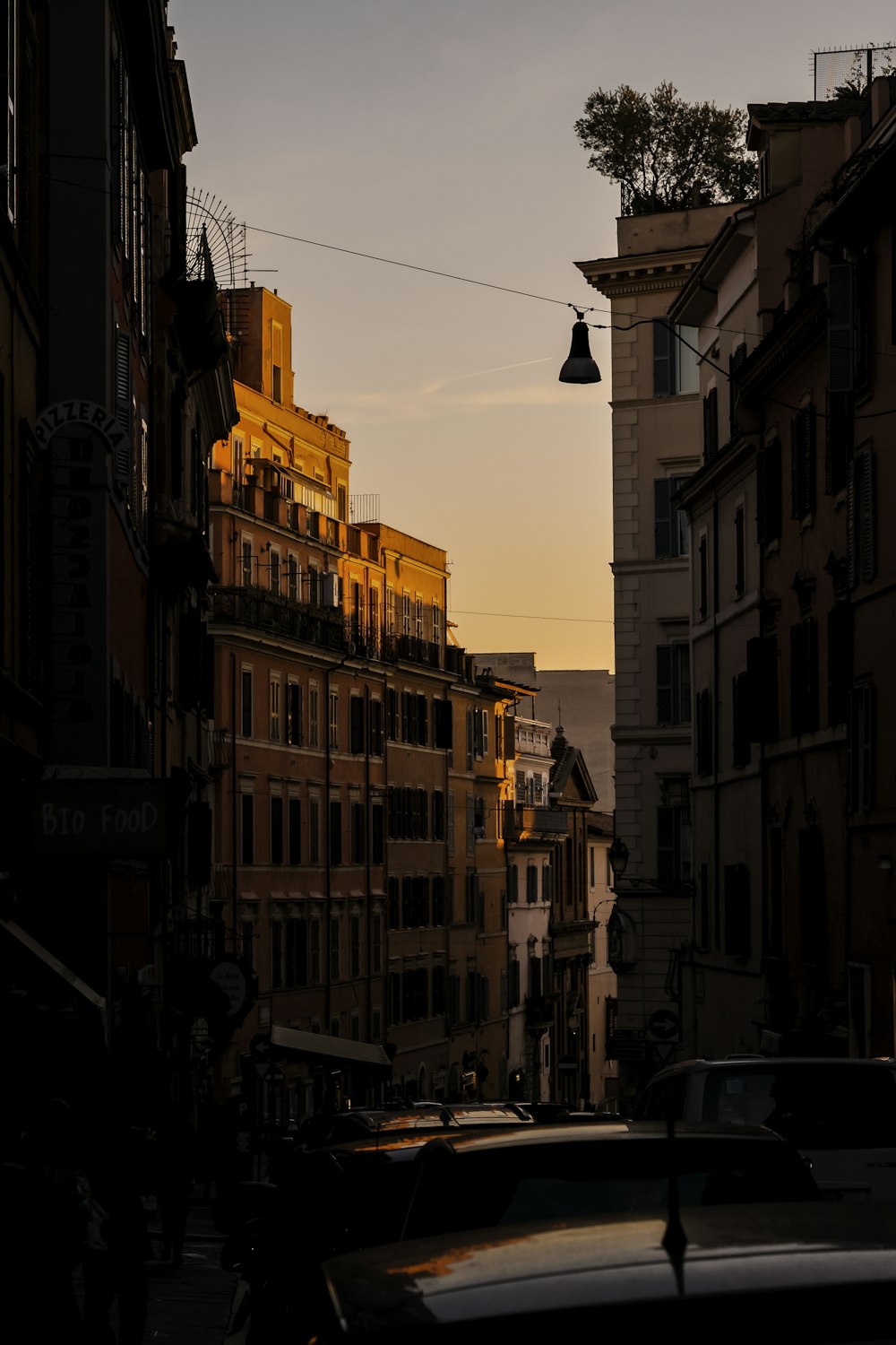 a view of a street in a city at sunset