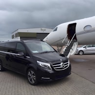 Mercedes Vito VIP vehicle arriving at a busy airport terminal for passenger transfer.