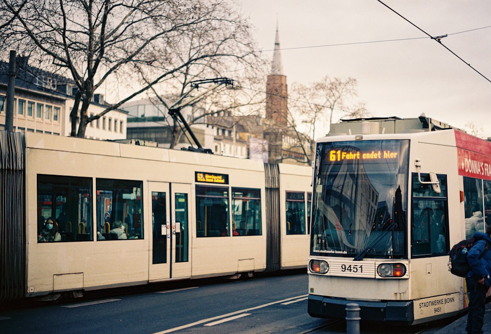 a couple of buses parked next to each other on a street