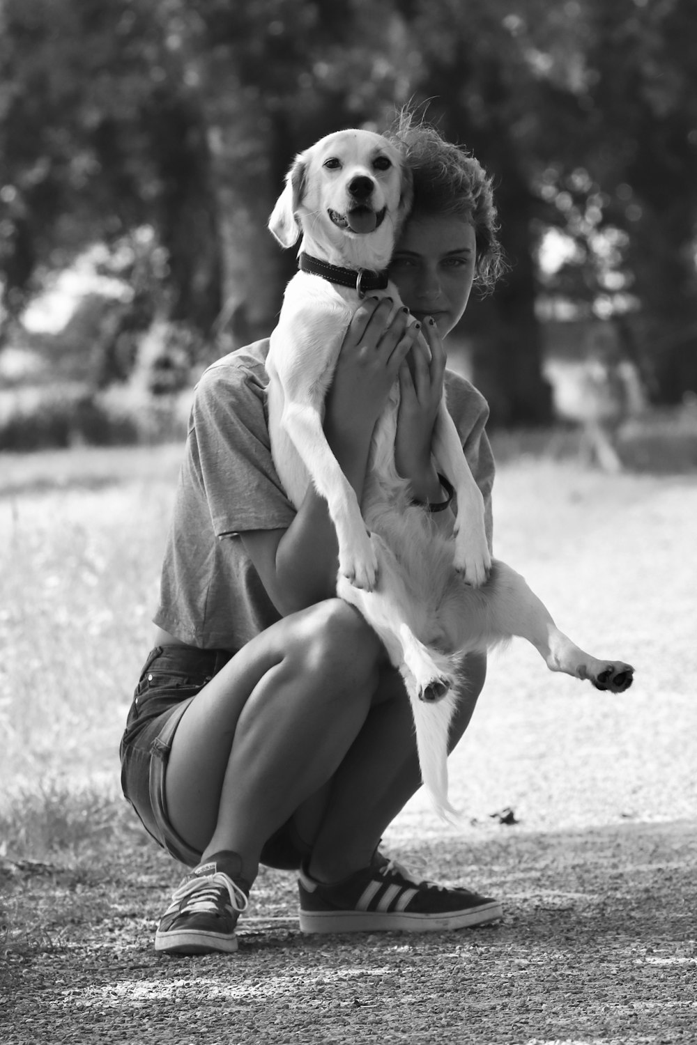 a woman is holding a dog in her arms
