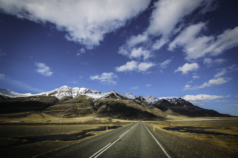 a long road with a mountain in the background