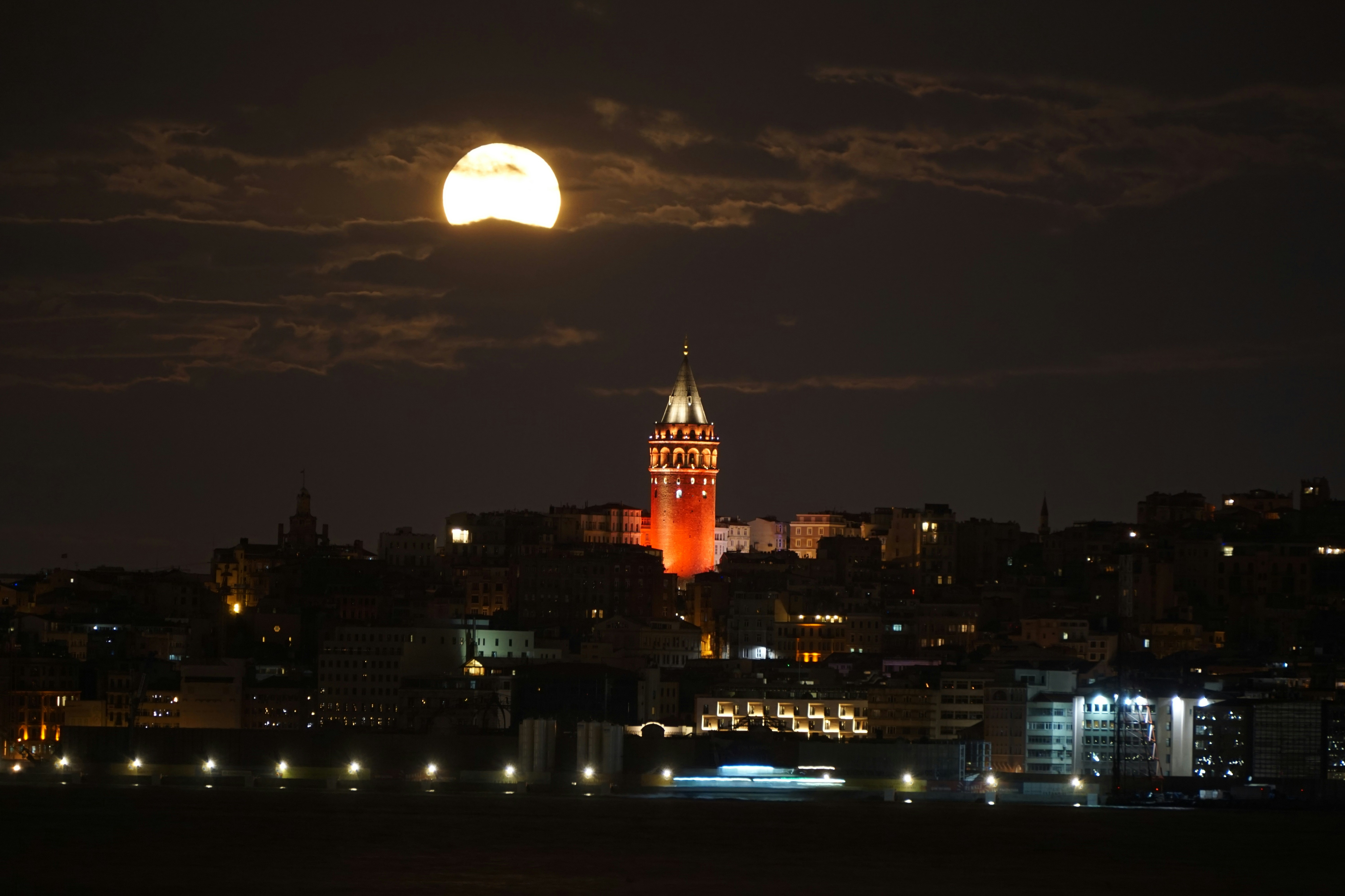 A full moon is seen over a city at night photo – Free Galata tower ...