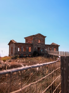 an old house sitting on top of a hill