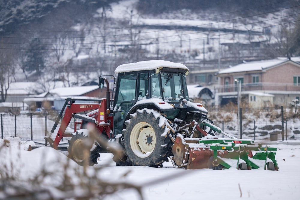 a tractor with a plow in the snow