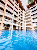 a large swimming pool next to a tall building