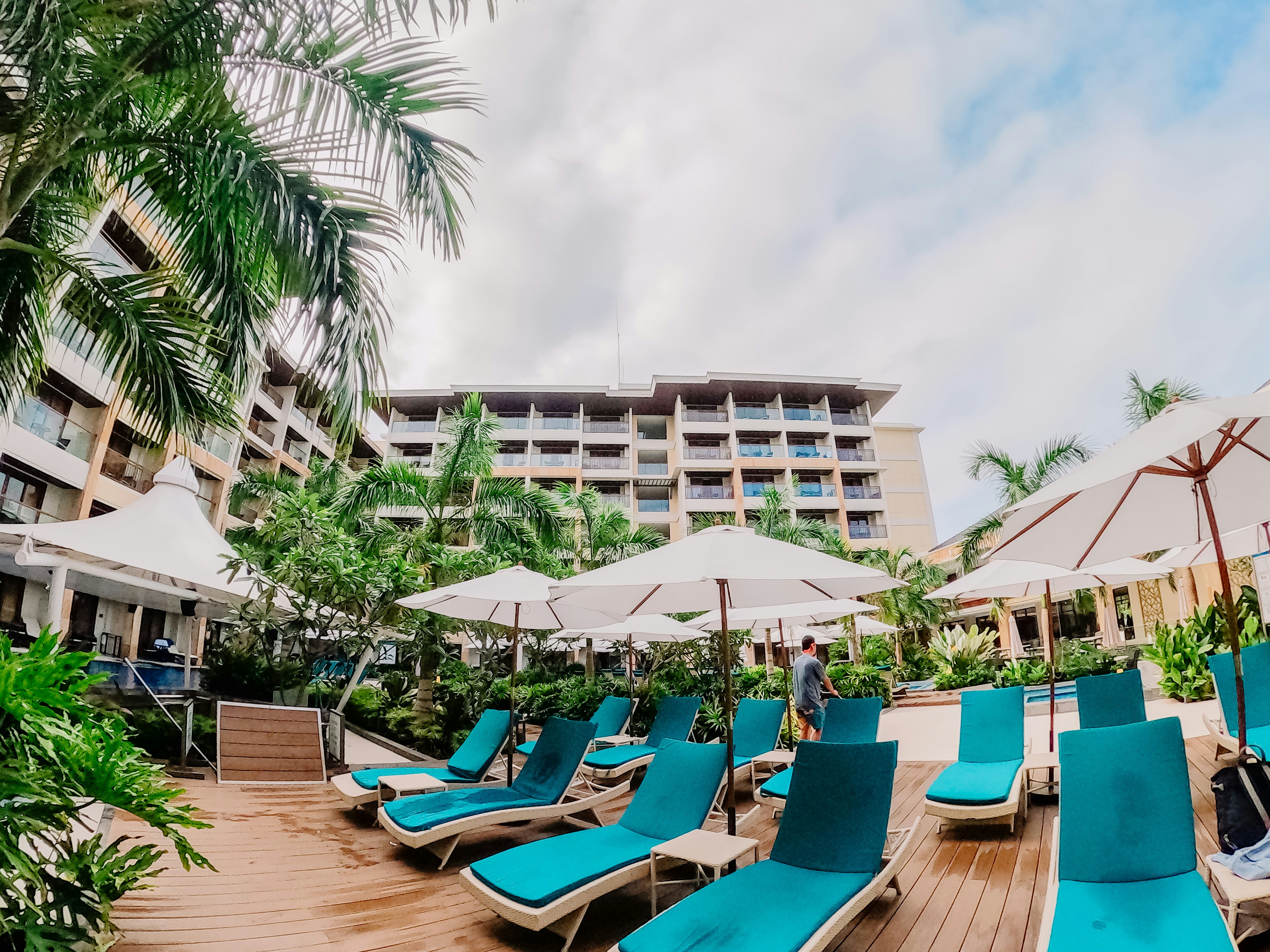 a group of lounge chairs sitting on top of a wooden deck