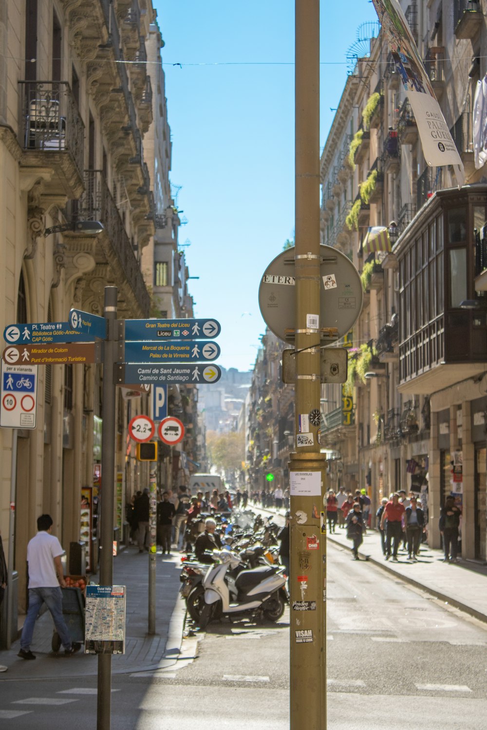 a city street filled with lots of people and motorcycles