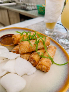 a plate of food on a table next to a glass of orange juice