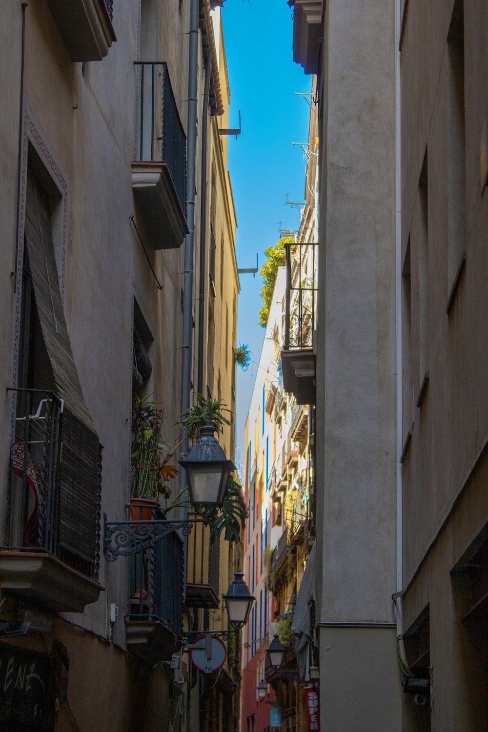 a narrow city street lined with tall buildings