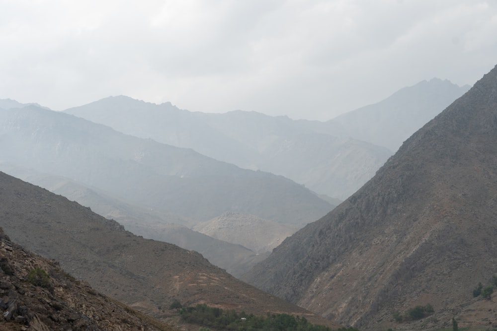 a view of a valley with mountains in the background