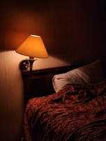 A cozy bedroom adorned with warm, inviting lamps.