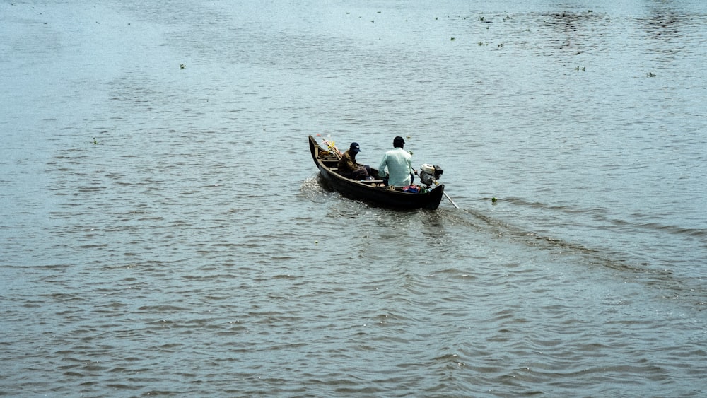two people in a small boat on a body of water