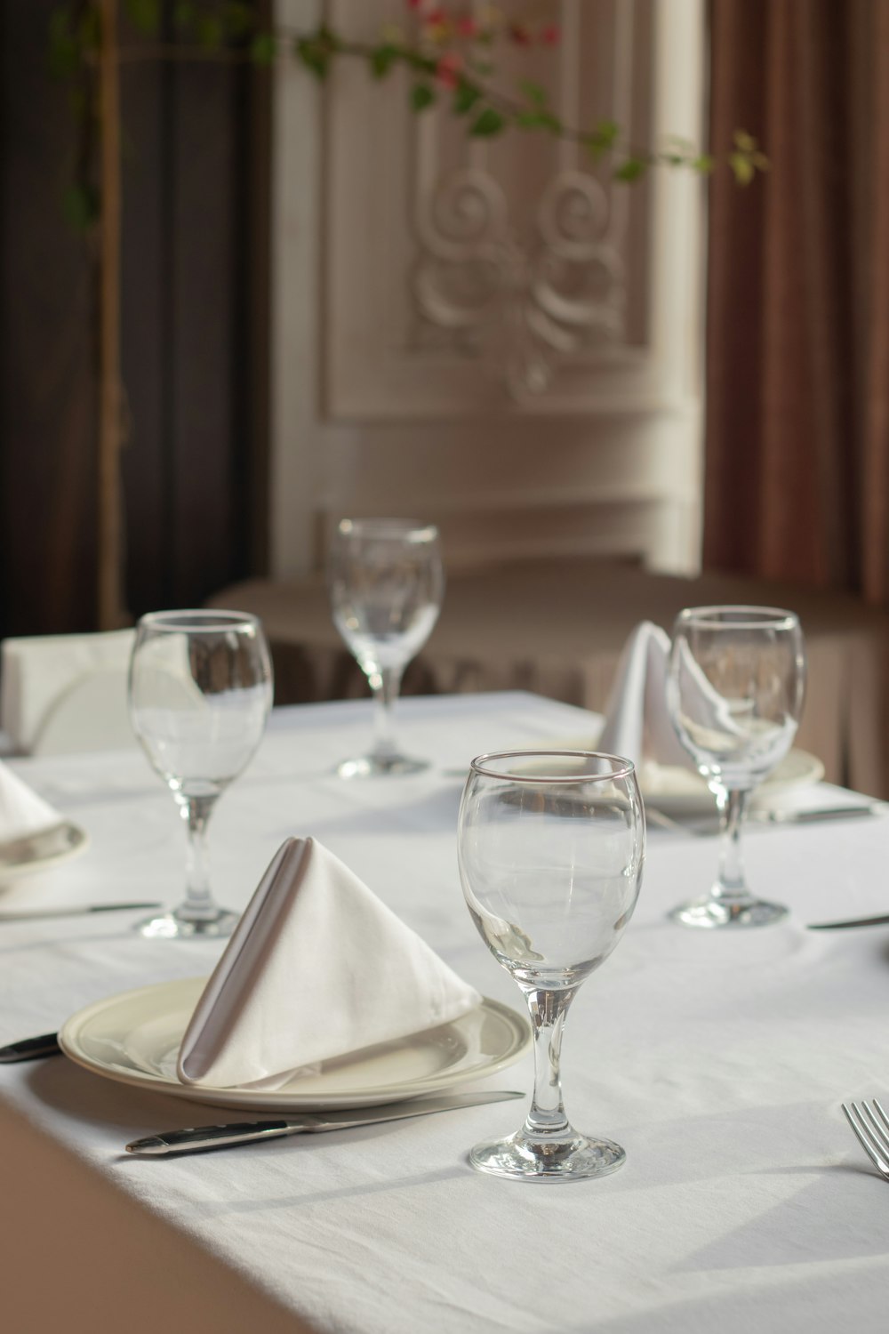 a table with a white table cloth and place settings