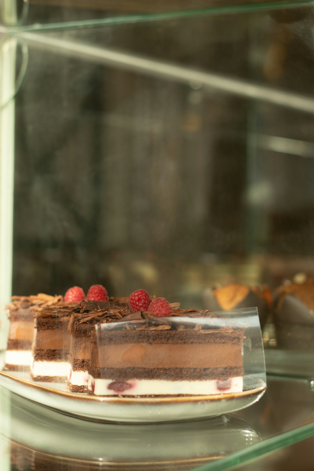 a plate of cake with raspberries on top of it