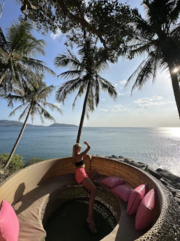 Elegant woman enjoying a sunny Palm Beach terrace with ocean view