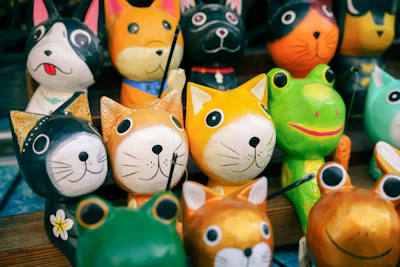 a group of colorful cat figurines sitting on top of a table