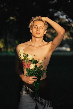 An elegant outdoor shoot with a model among blooming flowers, soft natural lighting.