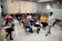 A bright, modern classroom filled with engaged students and a professor explaining business concepts.