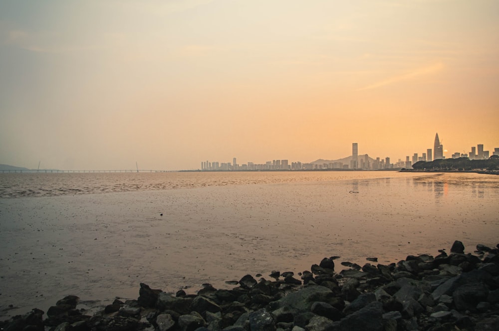 a large body of water with a city in the background